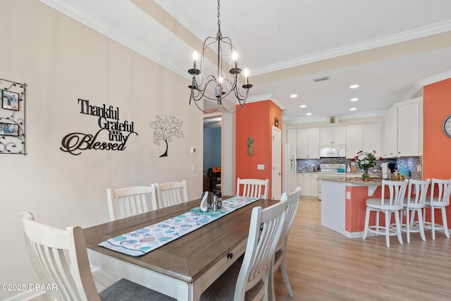 310 Coral Reef Way, Daytona Beach, FL 32124 - dining area featuring ornamental molding, recessed lighting, light wood-style flooring, and an inviting chandelier