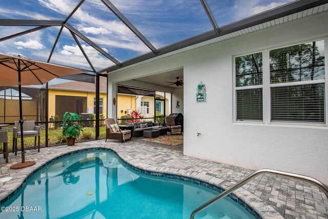 view of swimming pool featuring glass enclosure, a patio, and an outdoor hangout area