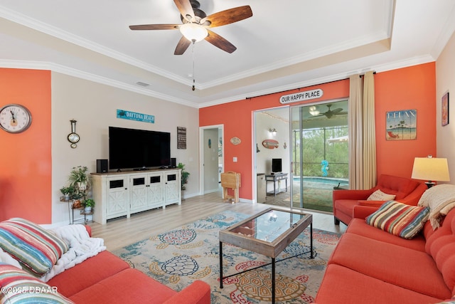 310 Coral Reef Way, Daytona Beach, FL 32124 - living area with light wood finished floors, visible vents, a raised ceiling, ceiling fan, and crown molding
