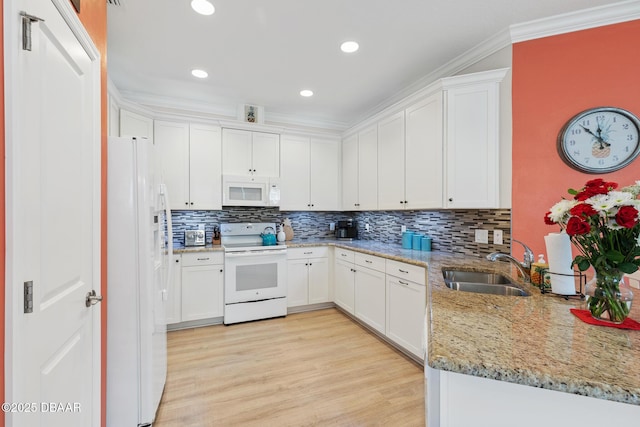 310 Coral Reef Way, Daytona Beach, FL 32124 - kitchen with light wood-style flooring, white cabinets, a sink, light stone countertops, and white appliances