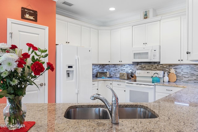310 Coral Reef Way, Daytona Beach, FL 32124 - kitchen with light stone counters, white appliances, white cabinetry, and a sink