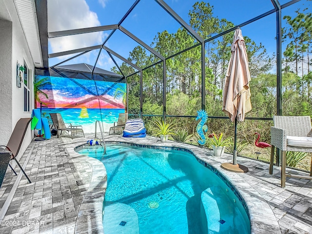 view of pool with a lanai and a patio area