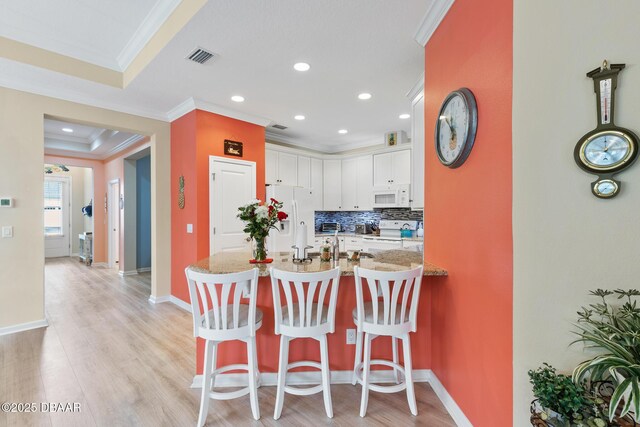 kitchen with ornamental molding, sink, light hardwood / wood-style floors, dishwasher, and ceiling fan with notable chandelier