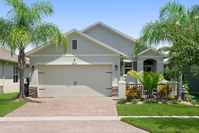 craftsman inspired home featuring a front lawn and a garage