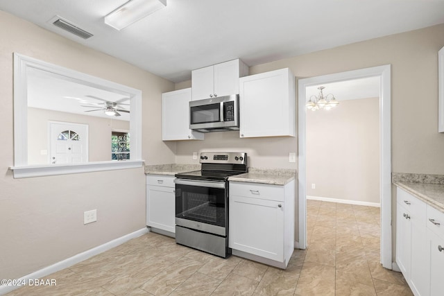 kitchen with ceiling fan with notable chandelier, stainless steel appliances, and white cabinetry