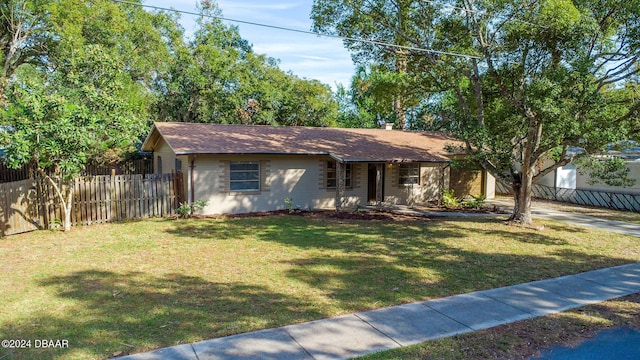 ranch-style home featuring a front lawn