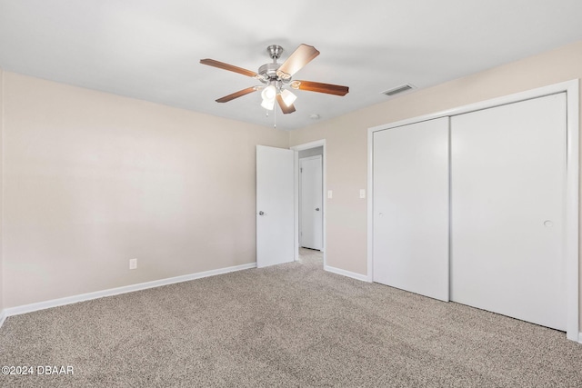 unfurnished bedroom featuring carpet, ceiling fan, and a closet