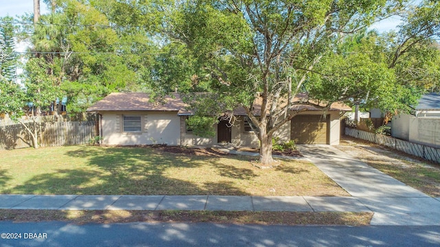 view of front facade featuring a front yard and a garage