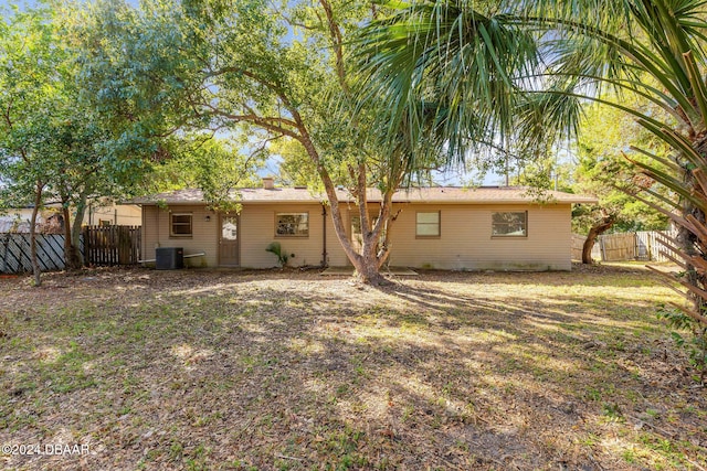 back of property featuring a yard and cooling unit