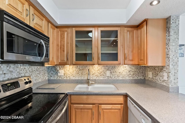 kitchen featuring stainless steel appliances, tasteful backsplash, and sink