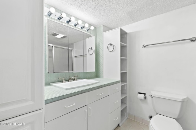 bathroom with vanity, tile patterned flooring, toilet, a textured ceiling, and an enclosed shower