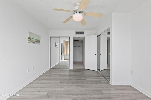 interior space featuring ceiling fan, light hardwood / wood-style flooring, and a textured ceiling