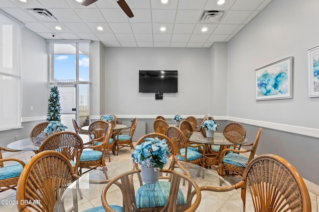 interior space with a drop ceiling and ceiling fan