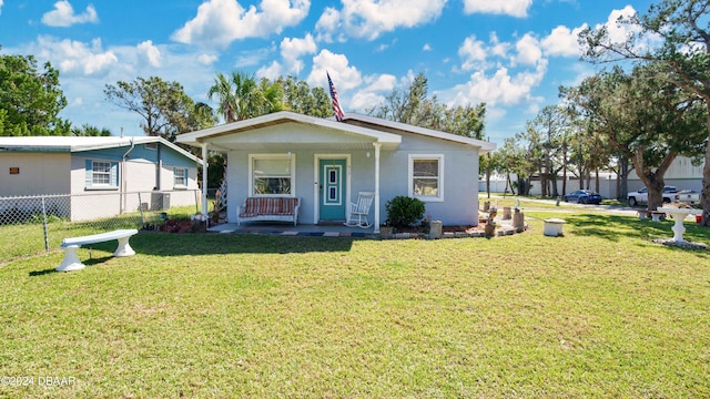 view of front of house with a front yard and covered porch