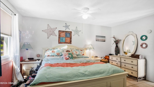 bedroom with ceiling fan and light tile patterned floors