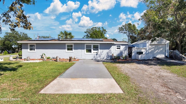 ranch-style house with a front yard and solar panels