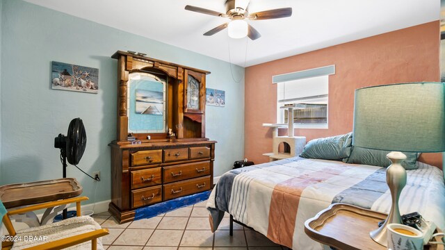 tiled bedroom featuring ceiling fan