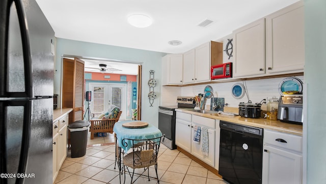 kitchen with ceiling fan, white cabinetry, light tile patterned floors, and black appliances