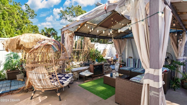 view of patio featuring outdoor lounge area and a gazebo