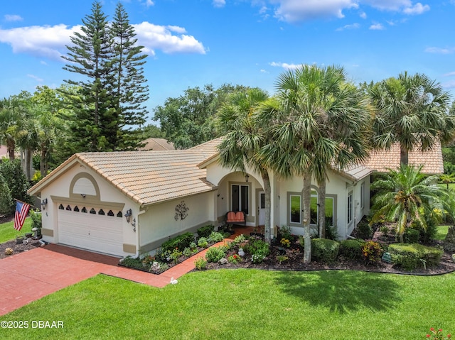 414 Long Cove Ct, Ormond Beach, FL 32174 - view of front facade with a garage, a front lawn, stucco siding, decorative driveway, and a tile roof