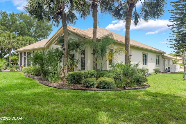 414 Long Cove Ct, Ormond Beach, FL 32174 - view of home's exterior featuring stucco siding, a lawn, and a tiled roof