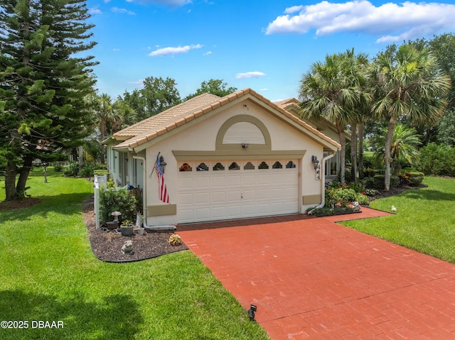 414 Long Cove Ct, Ormond Beach, FL 32174 - mediterranean / spanish-style home featuring decorative driveway, a front yard, stucco siding, and a garage