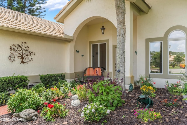 414 Long Cove Ct, Ormond Beach, FL 32174 - doorway to property featuring stucco siding and a tiled roof