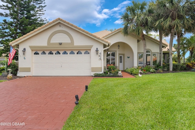 414 Long Cove Ct, Ormond Beach, FL 32174 - view of front of property with stucco siding, decorative driveway, and a front lawn