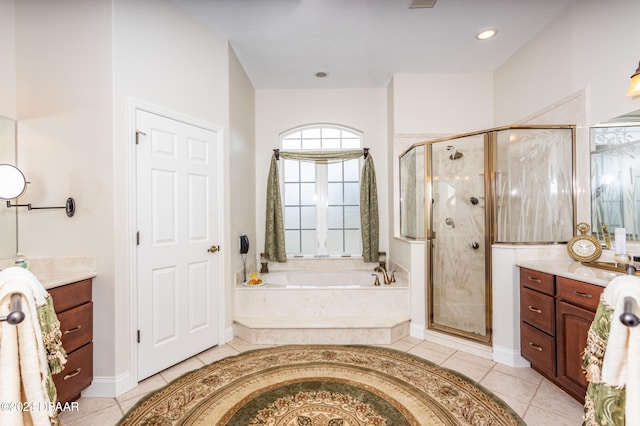 bathroom with plus walk in shower, vanity, and tile patterned flooring