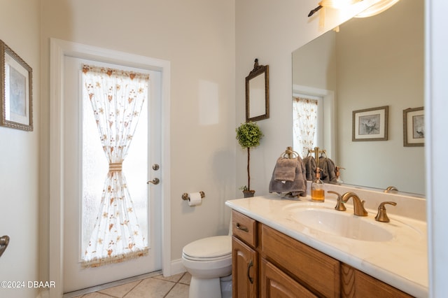 bathroom with tile patterned flooring, vanity, and toilet