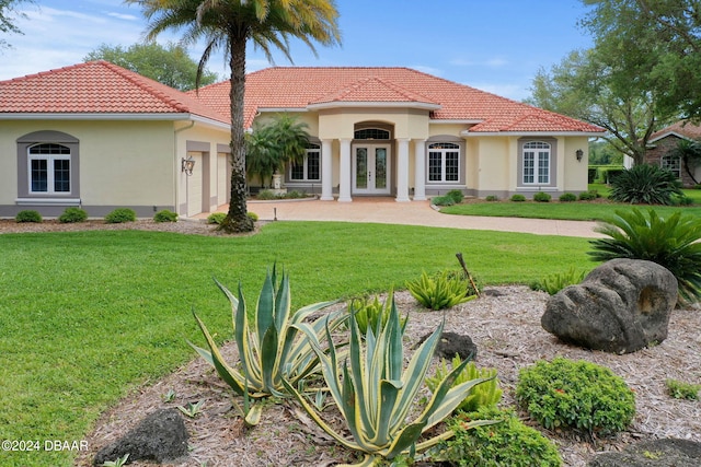 exterior space with french doors and a yard