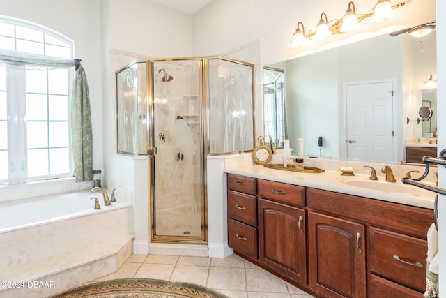 bathroom featuring vanity, tile patterned flooring, and separate shower and tub