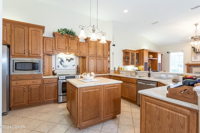 kitchen featuring light tile patterned flooring, stainless steel appliances, pendant lighting, vaulted ceiling, and kitchen peninsula