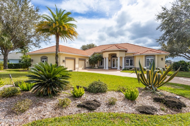 mediterranean / spanish-style house featuring a front lawn and a garage