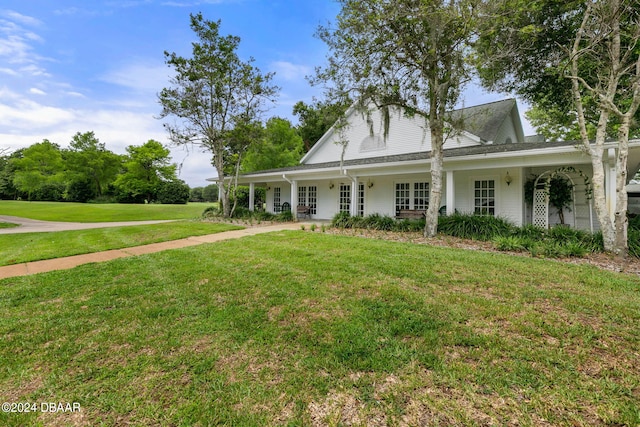 farmhouse inspired home with a porch and a front lawn