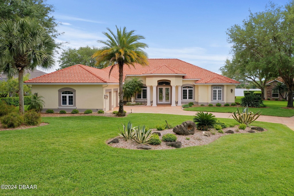 rear view of property featuring a lawn