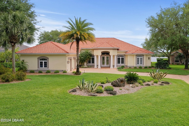 rear view of property featuring a lawn