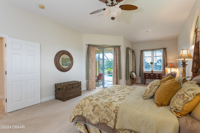 bedroom with ceiling fan, access to exterior, multiple windows, and light carpet