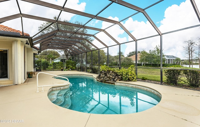 view of pool with glass enclosure and a patio