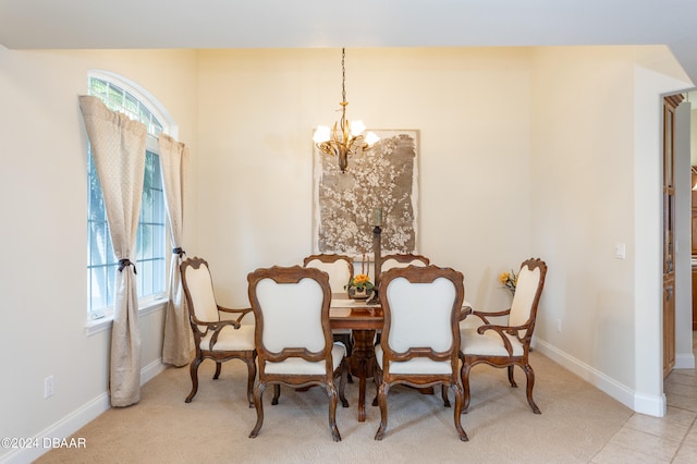 dining area featuring an inviting chandelier, light colored carpet, and a healthy amount of sunlight