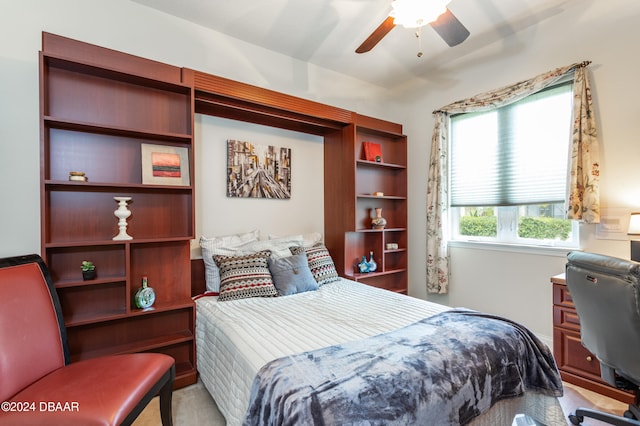 bedroom featuring light colored carpet and ceiling fan