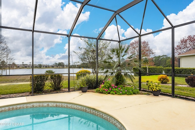 view of pool with a water view, glass enclosure, and a patio