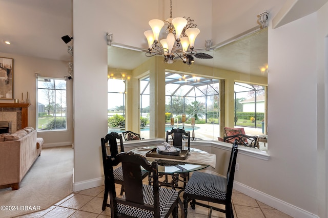 dining area featuring a tiled fireplace and light tile patterned floors