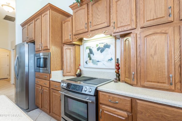 kitchen featuring appliances with stainless steel finishes and light tile patterned floors