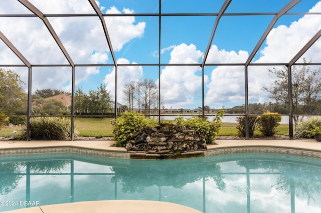 view of pool featuring a lanai and a water view