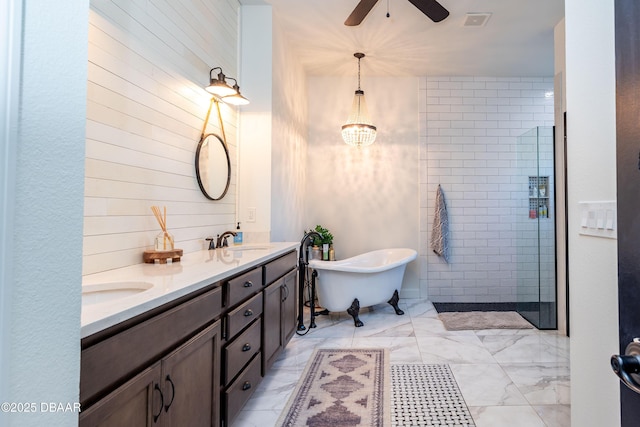 bathroom with ceiling fan with notable chandelier, shower with separate bathtub, and vanity