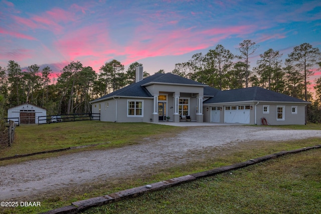 view of front of property featuring a lawn and a garage