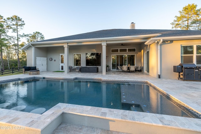 view of pool with a patio area, grilling area, and ceiling fan