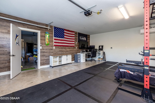 garage with wooden walls and a garage door opener