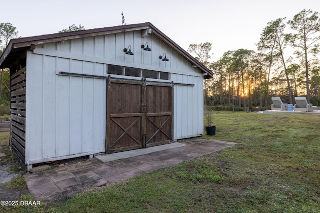 outdoor structure at dusk with a lawn